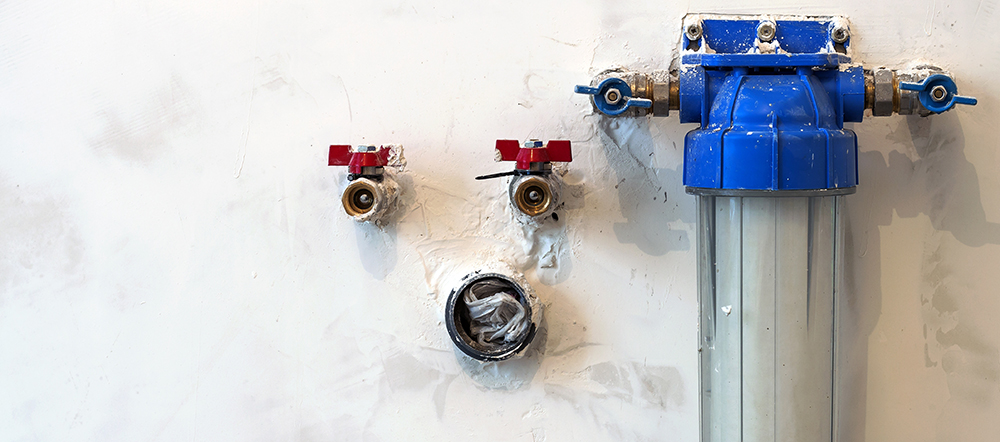 Water filter new installed on a kitchen wall to purify things like chlorine from drinking water
